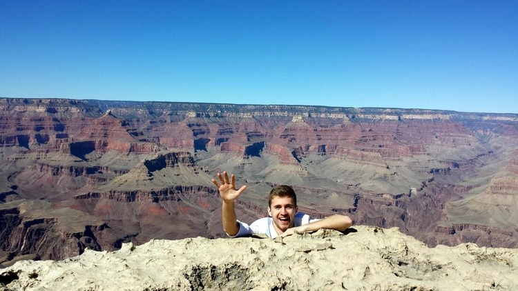 Sebastian jokingly falling down the Grand Canyon