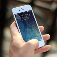 A traveler using his smartphone to access information using the internet while traveling