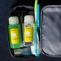 Travel-size toiletries in a traveler's toiletry bag designed to pass through airport security in a carry-on bag