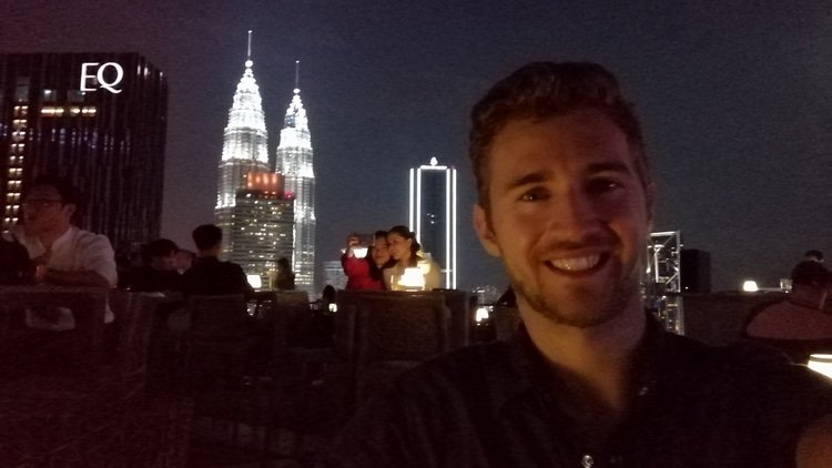 Sebastian from Travel Done Simple taking a selfie on a rooftop bar in Kuala Lumpur Malaysia