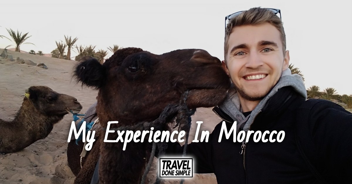 Sebastian from Travel Done Simple with a camel in the Sahara Desert in Morocco